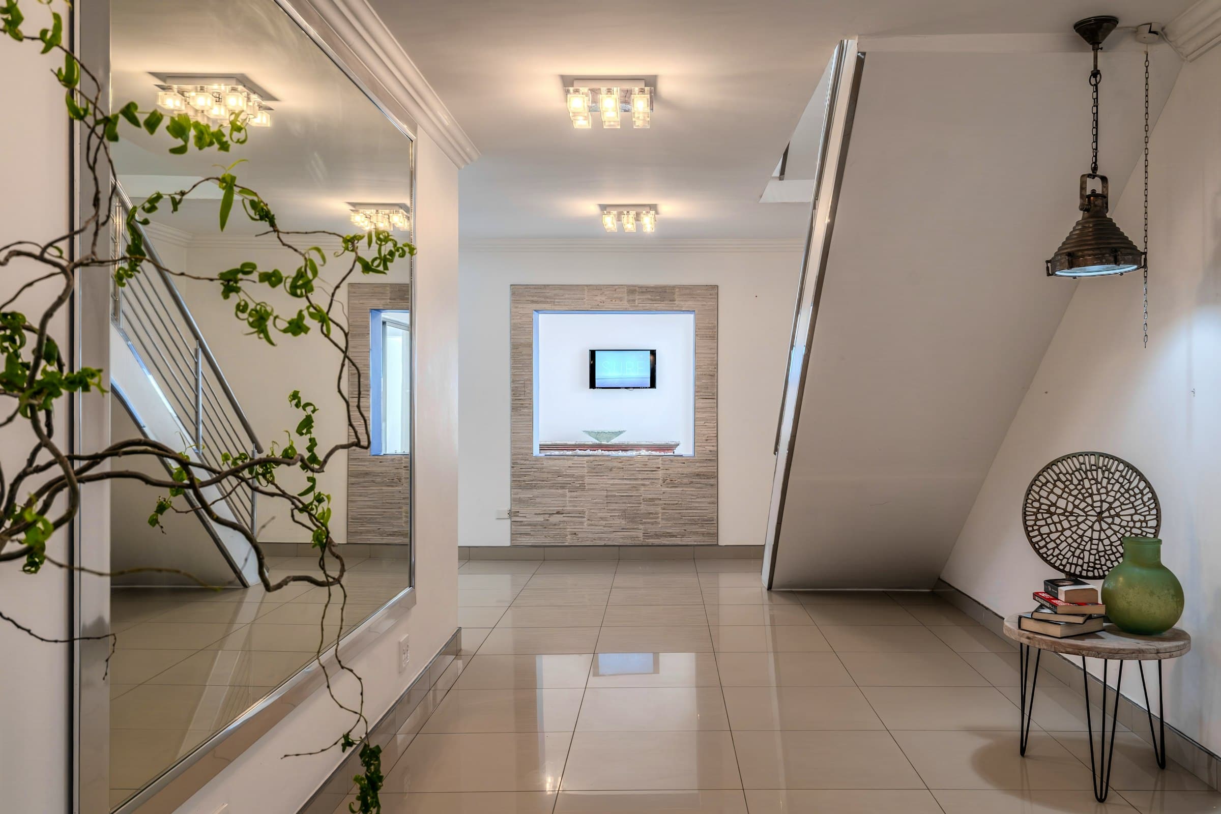Entrance hall with tiled floor, staircase and wall mirror