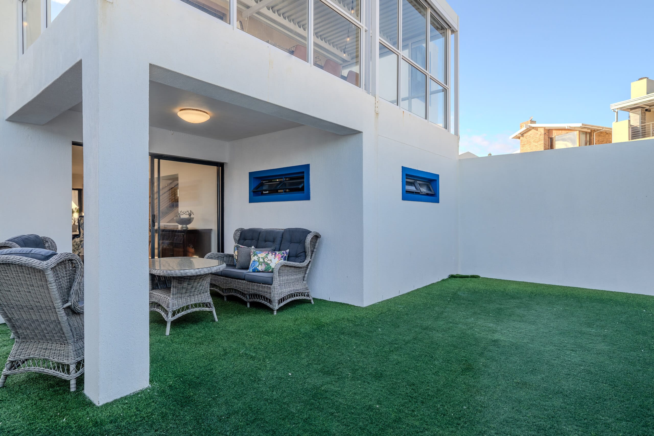 A double-volume internal courtyard at The Lighthouse, planted and washed with daylight from above
